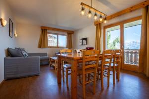 a dining room with a wooden table and chairs at Pracondu 1 101 - OUTDOOR & FUN apartment 8 pers in Nendaz