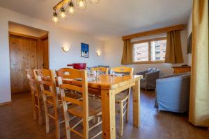 a dining room with a wooden table and chairs at Pracondu 1 101 - OUTDOOR & FUN apartment 8 pers in Nendaz +11 photos