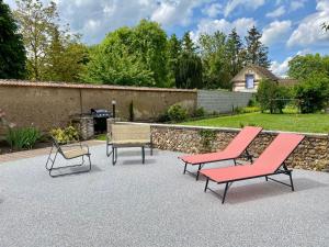 a group of chairs sitting on a patio at Maison Fleurs de bobo in Les Minières
