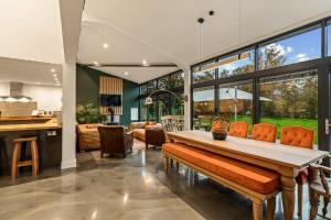 a kitchen and dining room with a wooden table and chairs at Dragons Barn with Hot Tub in Great Malvern