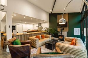 Una sala de estar con dos sofás y una chimenea. en Dragons Barn with Hot Tub, en Great Malvern