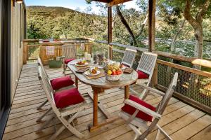 a wooden deck with a table and chairs on it at Au Paradis des Campeurs in Les Issambres