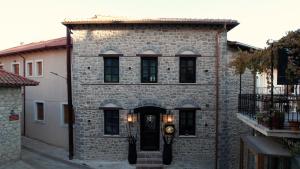 a brick building with a clock on the front of it at Maison Michelangelo in Arachova