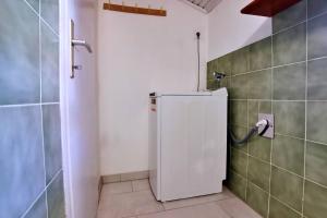 a kitchen with a white refrigerator in a room at Apartments Srdoc in Šilo +61 photos