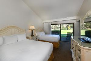 a hotel room with two beds and a window at 656 Cottages at Silverado condo in Napa