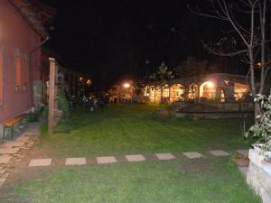 a yard of a house at night with lights at Kerámiapark Guesthaus in Budapest