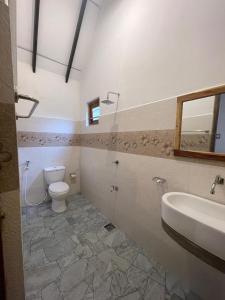 a bathroom with a toilet and a sink at White Sand Bungalow Yala in Yala
