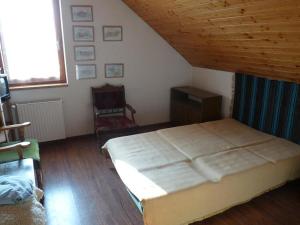 a bedroom with a large bed and a wooden ceiling at Kerámiapark Guesthaus in Budapest