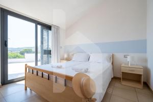 a bedroom with a large bed and a large window at Homiday - Holiday Rendez Vous in Pineto +174 photos