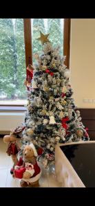 ein Weihnachtsbaum mit Teddybären davor in der Unterkunft AMK House - Busteni in Buşteni