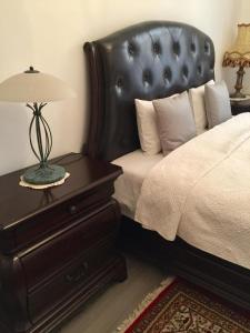 a bedroom with a bed with a lamp on a nightstand at IL Piccolo Castello Busteni in Buşteni