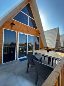 a large wooden house with a table and chairs at Loft karpasia in Rizokarpaso