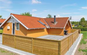 a house with a wooden fence in front of it at Holiday Home Teglbakken Vi in Egernsund