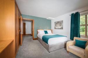 a hotel room with a bed and a chair at Brennan Court Guest Accommodation in Limerick +20 photos