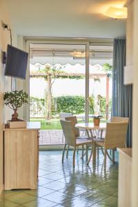 a dining room with a table and chairs and a window at Ancora Resort in Acciaroli +93 photos