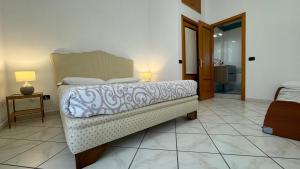 a bedroom with a bed and a bathroom at B&B Eracle in Ercolano