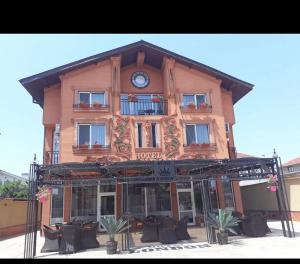 a large building with a clock on top of it at Хотел ЛОНДОН in Svilengrad