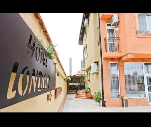 a building with a sign on the side of it at Хотел ЛОНДОН in Svilengrad +12 photos