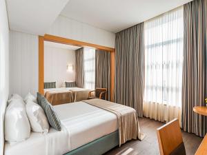 Ein Bett oder Betten in einem Zimmer der Unterkunft Mercure Lisboa Almada