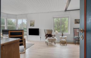 sala de estar con paredes blancas y TV en Holiday Home Rislumvej Rømø Ix, en Rømø Kirkeby
