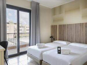Postel nebo postele na pokoji v ubytování B&B HOTEL Pomezia Cortese