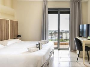 Postel nebo postele na pokoji v ubytování B&B HOTEL Pomezia Cortese