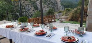 a table with plates of food on top of a mountain at Casa Jerónimo in Loporzano