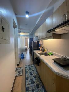 a kitchen with a sink and a counter top at 1 BR Condo with balcony in Verdon Parc Trevans 512 in Davao City