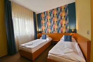 Postel nebo postele na pokoji v ubytování Hotel Platan