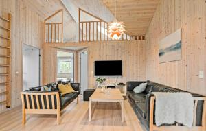 a living room with a couch and a table at Beautiful Home In Idestrup With Sauna in Marielyst