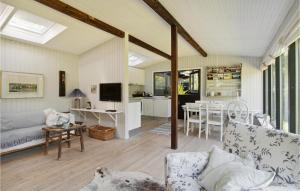 a living room with a couch and a table at 2 Bedroom Nice Home In Vejby in Vejby