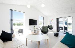 a white living room with a couch and a table at Awesome Home In Jerup With Kitchen in Bratten Strand