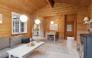 a living room with a couch and a table at Stunning Home In Ålbæk With Wifi in Ålbæk