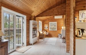 a living room with wooden walls and a wooden ceiling at Stunning Home In Ålbæk With Wifi in Ålbæk