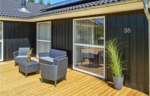 a screened in deck with two chairs on a house at Holiday Home Kuskevej Jerup X in Jerup