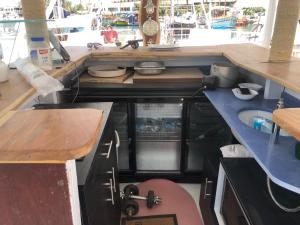 a kitchen with a counter and a sink in a boat at הפנינה הלבנה in Eilat +5 photos
