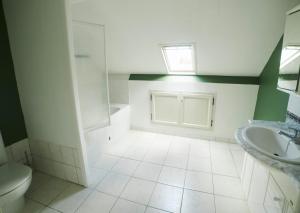 a bathroom with a toilet and a sink at Chambre Du Coq à la Ferme de Franqueville in Sainte-Marie-du-Mont