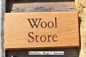 a wooden sign that reads wood store on a wall at Mickleton Hills Farm Cotswold Holiday Cottages in Chipping Campden