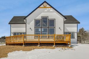 a house with a large deck in front of it at Meadowlark Mountain Club with Views of the Rockies in Bordenville