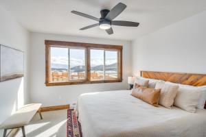 a bedroom with a bed with a ceiling fan at Meadowlark Mountain Club with Views of the Rockies in Bordenville