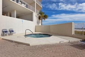 a swimming pool in front of a building at Lighthouse 1115 Condo on the beach 3BR 3BA in Gulf Shores