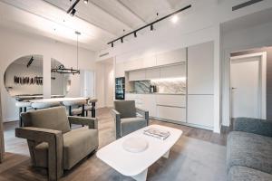 a living room with a couch and a table at The Diagonal Suites by Sweett in Barcelona
