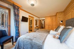 a bedroom with a bed with a teddy bear on it at Chalet Shalimar in Zermatt