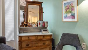 a room with a dresser with a mirror and a chair at Fewo-Gottmadingen in Gottmadingen +12 photos