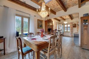 a kitchen and dining room with a table and chairs at Leśny Dworek Sominy - Dom z Sauną i Kominkiem in Sominy