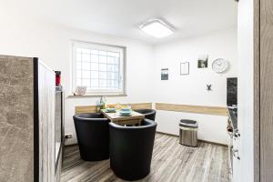 a room with two black stools and a table at Ferienwohnung Activities & Relax, Skilift&Downhill in Winterberg +25 photos