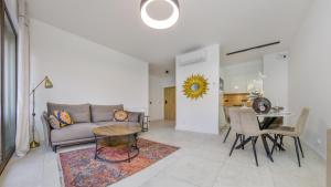 a living room with a couch and a table at Belnihel, Sun & Snow in Hel