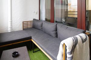 a couch sitting in front of a window at Ferienwohnung Activities & Relax, Skilift&Downhill in Winterberg