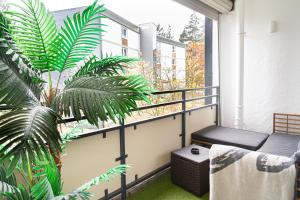 a balcony with a bench and a plant at Ferienwohnung Activities & Relax, Skilift&Downhill in Winterberg