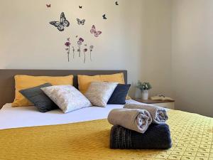 sypialnia z łóżkiem z motylami na ścianie w obiekcie Apartment Rozi w mieście Šilo